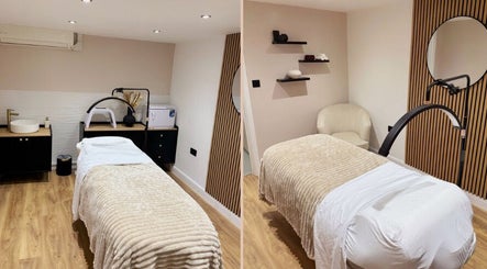 Elegant treatment room at Naked Beauty in North Weald Bassett, GB featuring a plush bed and soothing decor.