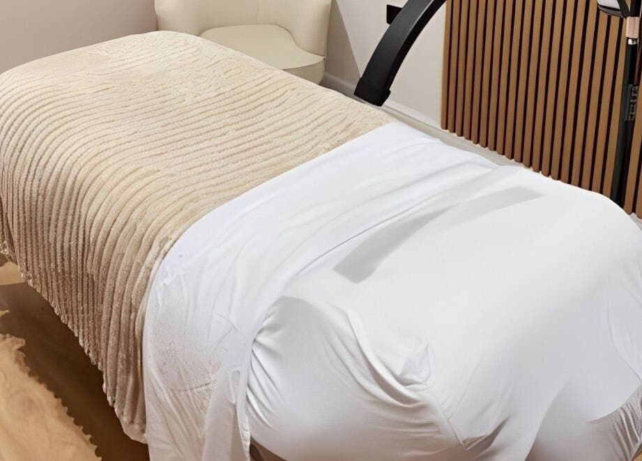 Relaxing treatment bed at Naked Beauty, North Weald Bassett, GB offering luxurious wellness experiences.