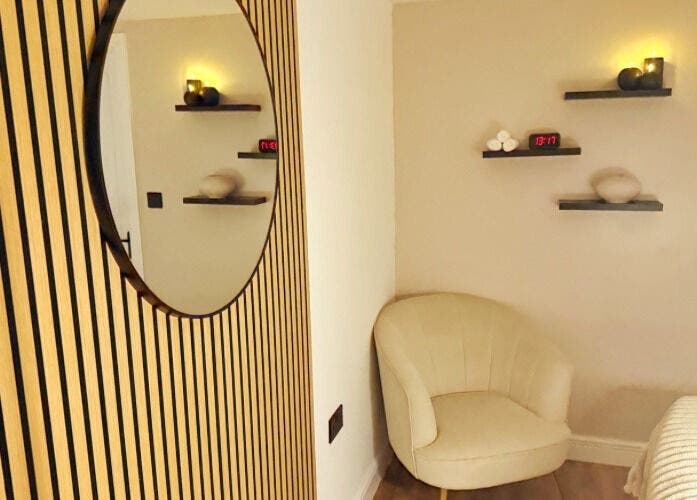 Cozy relaxation corner at Naked Beauty, North Weald Bassett, GB, featuring elegant decor and warm lighting.