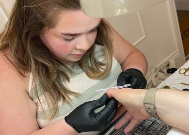 Nail artist working meticulously on a client's nails at Nails by Leah Rose, Dinnington, England, GB.