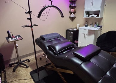 Relaxing treatment room at NC Beauty Bar, LLC in Milwaukee, Wisconsin, US featuring a plush massage table.