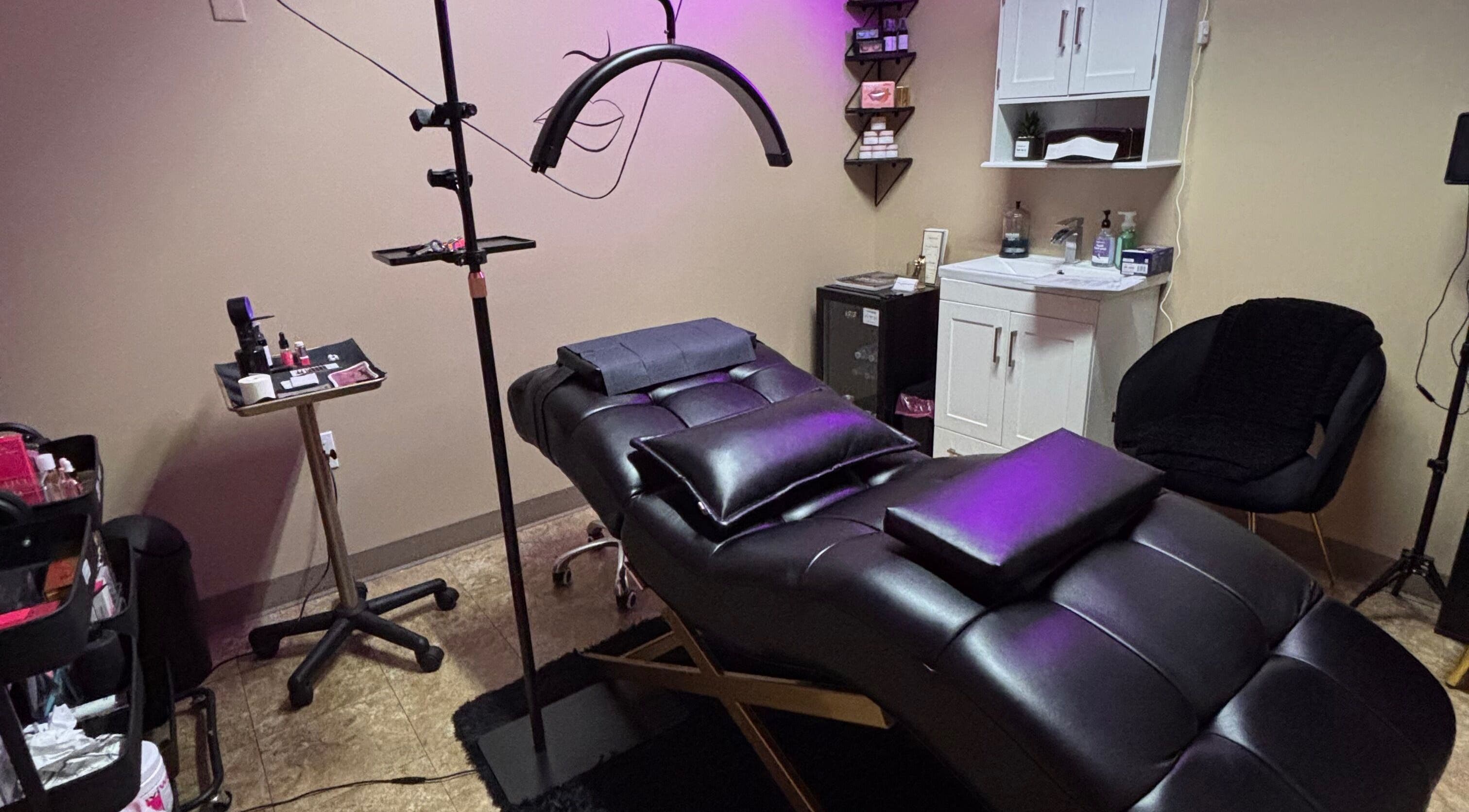 Luxurious spa room at NC Beauty Bar in Milwaukee, Wisconsin, US, with plush treatment bed and ambient lighting.