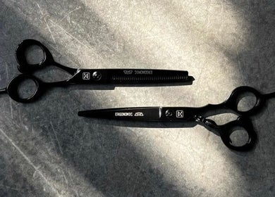 Black ergonomic barber shears at Nicco the Barber, Kansas City, Missouri, US, enhancing styling precision.