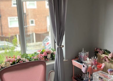 Charming makeup area at Dolled by D.X in Rotherham, England, GB with floral decor and beauty tools.
