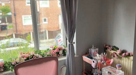 Charming makeup area at Dolled by D.X in Rotherham, England, GB with floral decor and beauty tools.