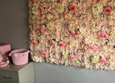 Elegant floral decor at Dolled by D.X, Rotherham, England, GB, featuring pink and cream blossoms on a wall.