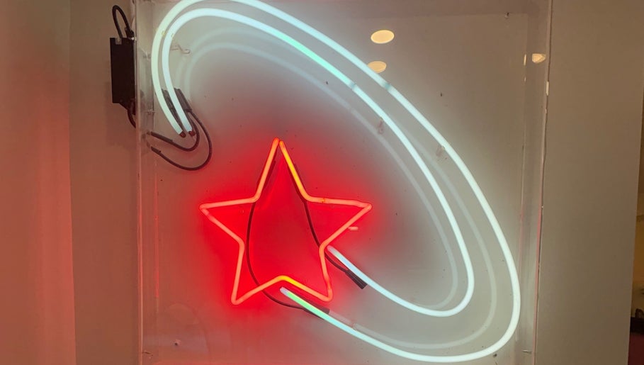 Neon star sign glowing at Danielle @ HEADS, Toronto, Ontario, CA, creating a vibrant atmosphere.