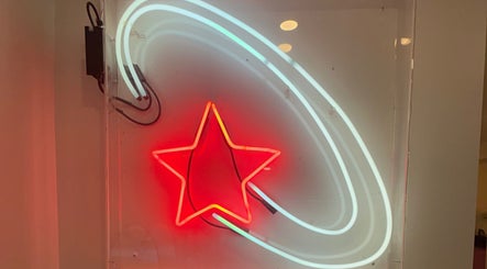 Neon star sign glowing at Danielle @ HEADS, Toronto, Ontario, CA, creating a vibrant atmosphere.