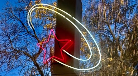 Neon star reflecting on window at Danielle @ HEADS in Toronto, Ontario, CA, enhancing the venue's allure.