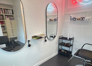 Modern salon interior at Danielle @ HEADS, Toronto, Ontario, CA with sleek mirrors and chairs.