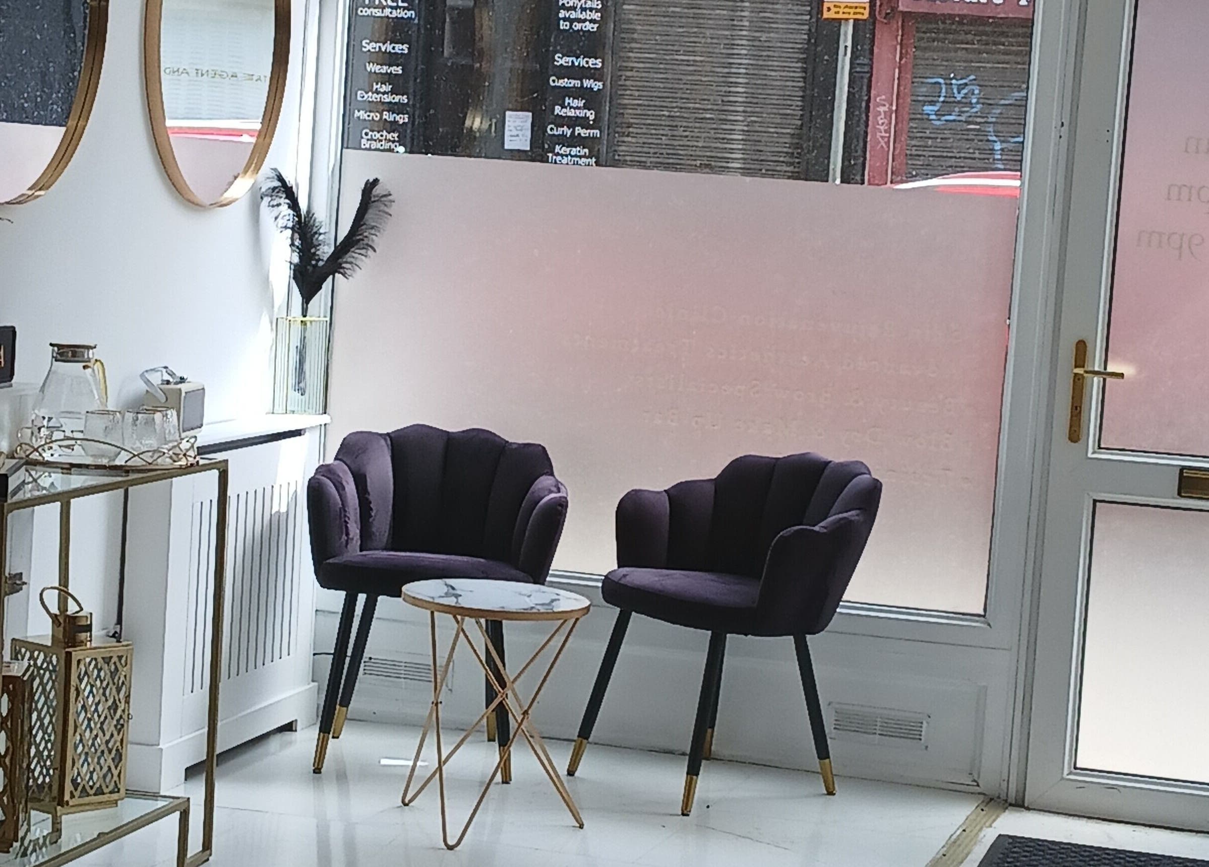 Sophisticated seating area at InnerGlow Aesthetics in Edinburgh, Scotland, GB featuring chic decor and plush chairs.