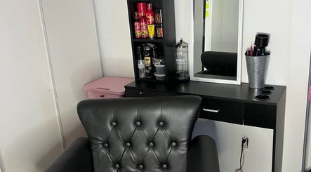 Chic styling station at Kluvv_hairbar, Toronto, Ontario, CA, featuring a black leather chair and grooming tools.