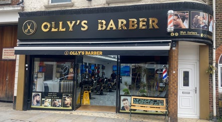 Exterior of Olly's Barber showcasing vibrant signage, located near Sean’s Chair in Sheerness, England, GB.