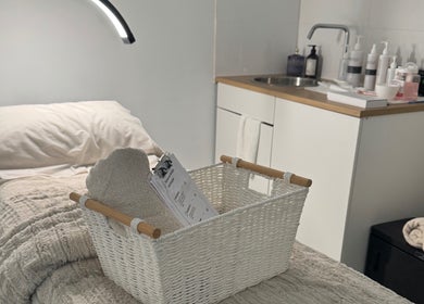 Relaxation space at The Derm Lounge, Woody Point, Queensland, AU, featuring cozy treatment bed and elegant decor.