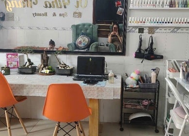 Oi Nha Trang Spa's inviting beauty area with orange chairs and nail polish display in Nha Trang, Khánh Hòa, VN.