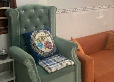 Elegant seating area at Oi Nha Trang Spa, Nha Trang, Khánh Hòa, VN, featuring plush chairs and cushions.