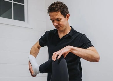 Therapist providing a leg stretch at NPC Sports Massage, Maidstone, England, GB.