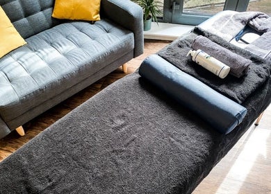 Massage table and comfy seating at NPC Sports Massage in Maidstone, England, GB offering relaxation and wellness.