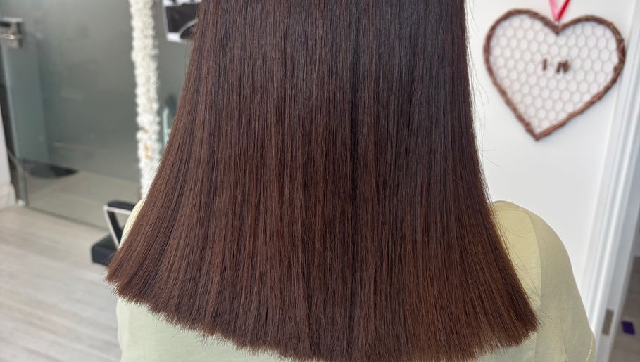Sleek brown hair styled straight at Levre beauty, London, England, GB.