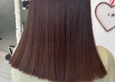Sleek brown hair styled straight at Levre beauty, London, England, GB.