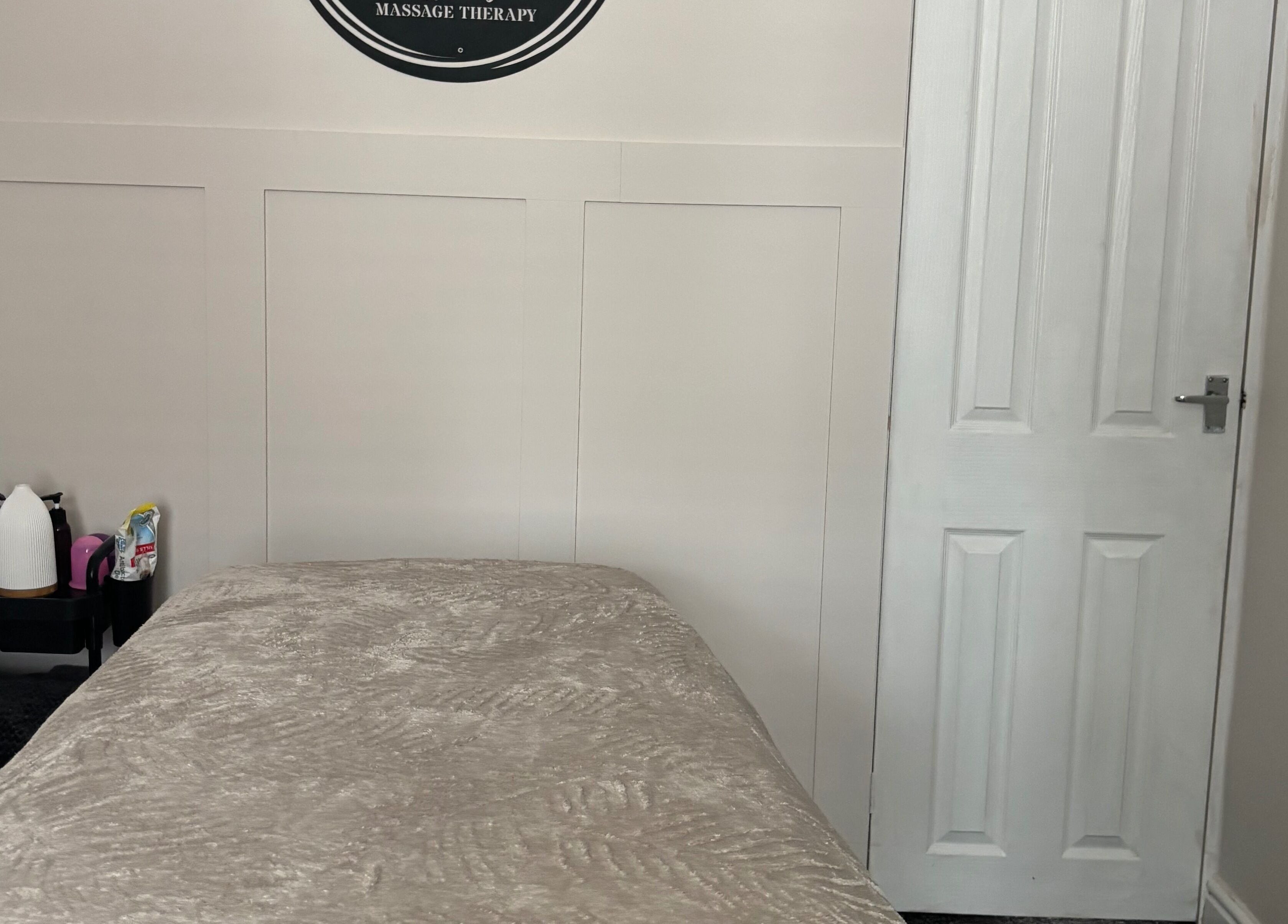 Cozy massage room at Affinity Massage in Leigh, England, GB, showcasing a relaxing setting.