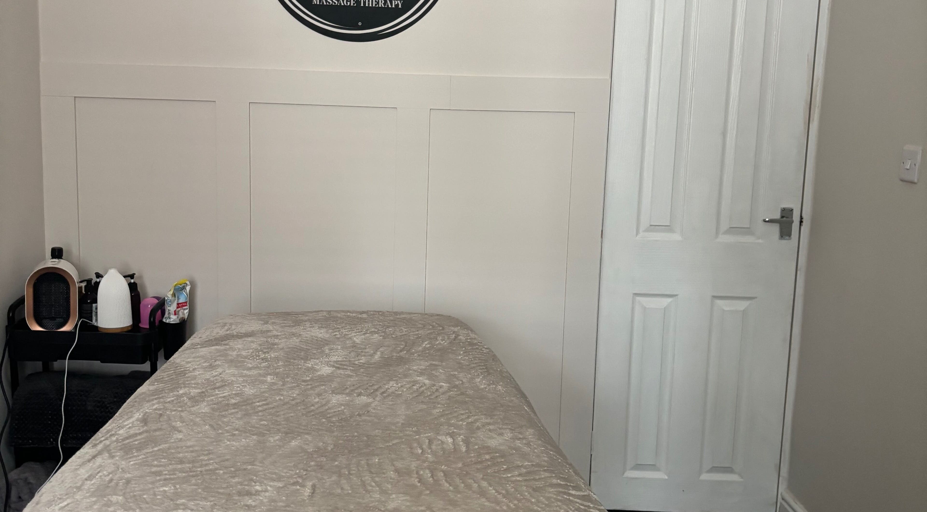 Cozy massage room at Affinity Massage in Leigh, England, GB, showcasing a relaxing setting.