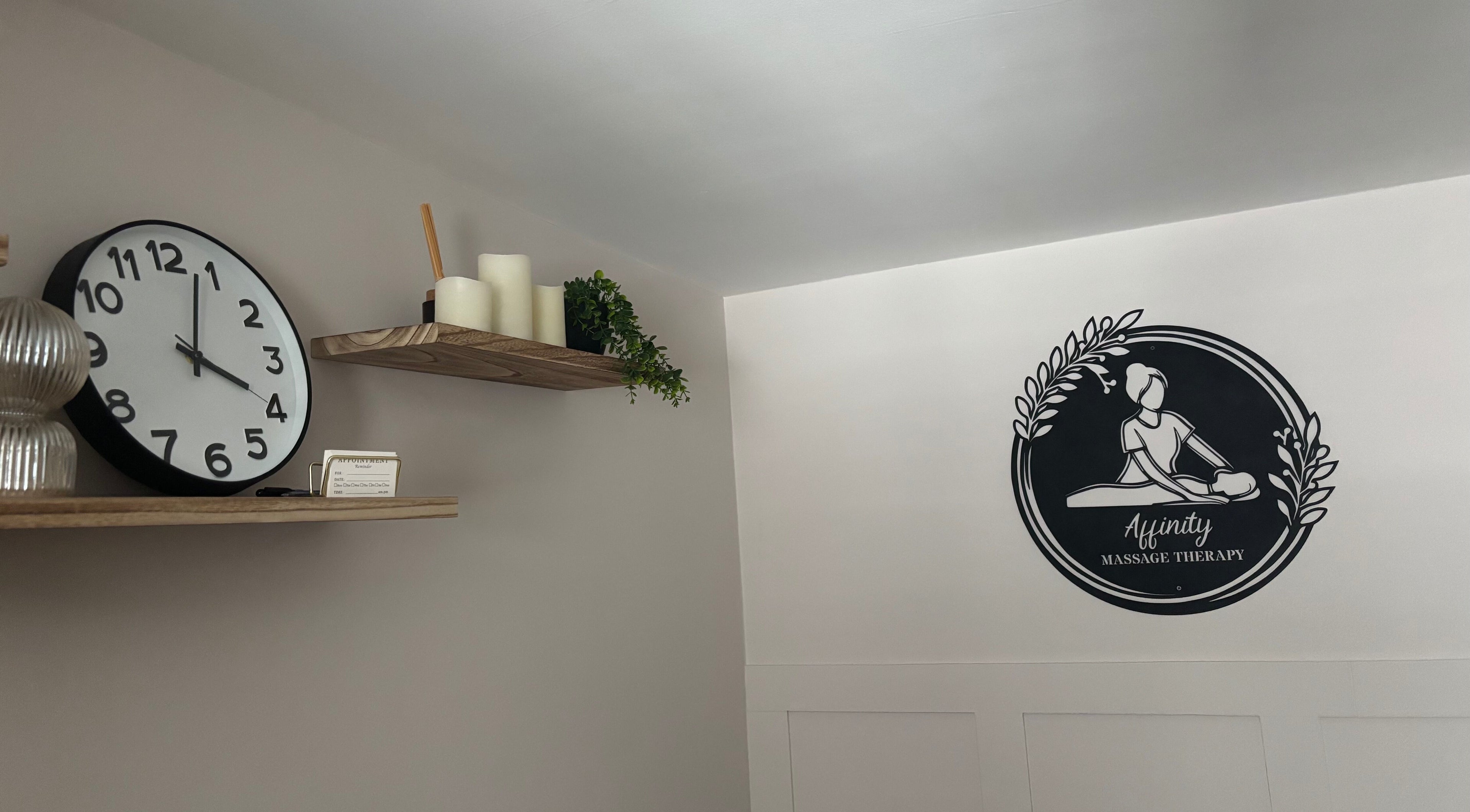 Elegant wall clock and Affinity Massage logo at Leigh, England, GB.