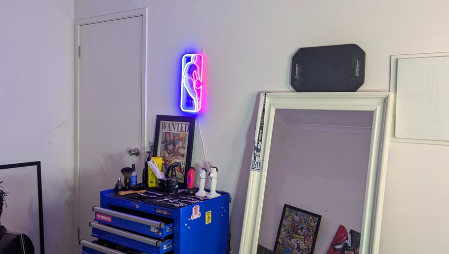Cozy decor at Slim Fadey barbershop, Melbourne, Victoria, AU with neon light and mirror setting.