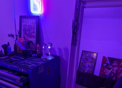 Slim Fadey barbershop in Melbourne, Victoria, AU with neon glow, grooming tools on a workbench.
