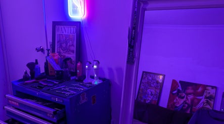 Slim Fadey barbershop in Melbourne, Victoria, AU with neon glow, grooming tools on a workbench.