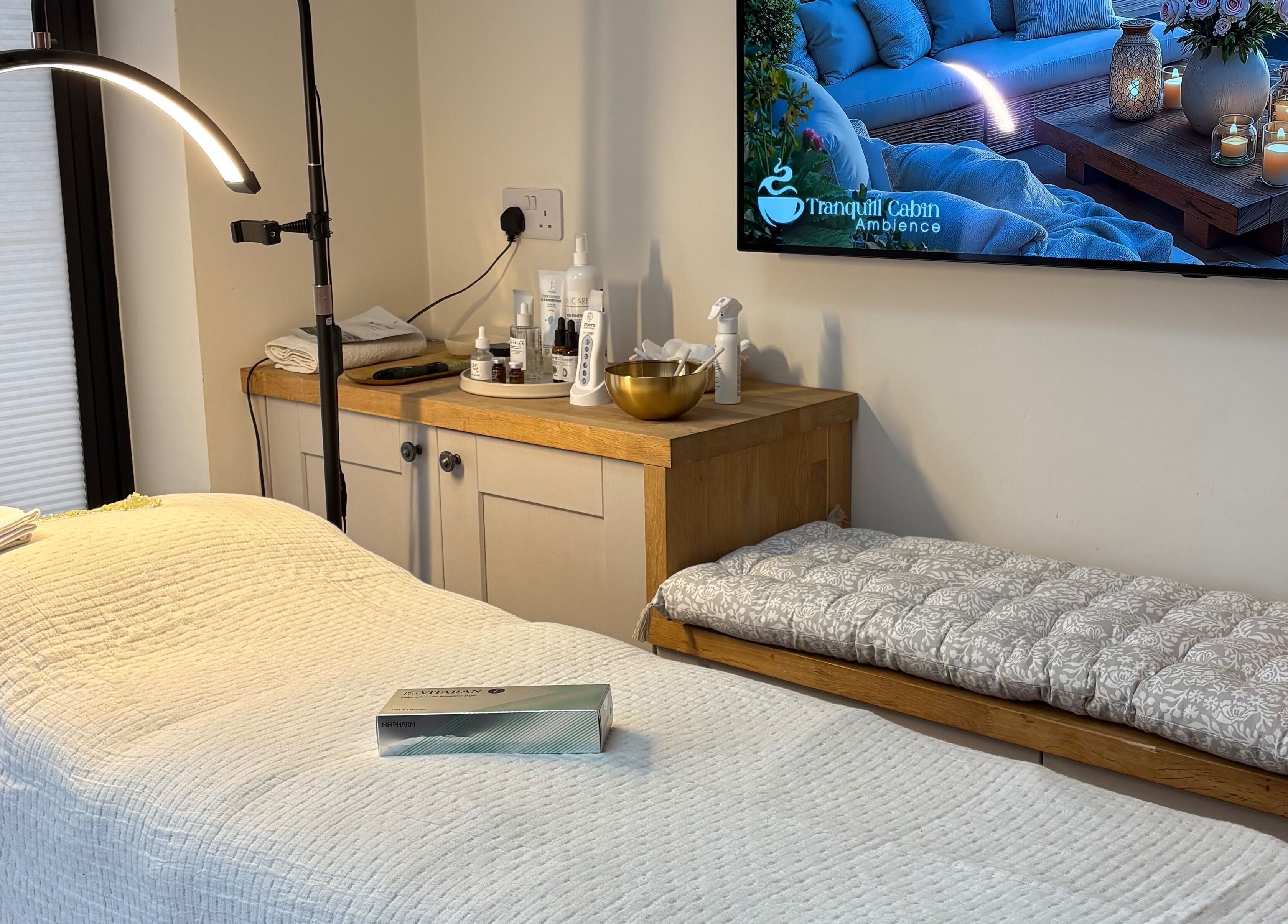 Cozy treatment room at Glow by Mykala, Carlton, England, GB, with a massage bed and soft ambient lighting.