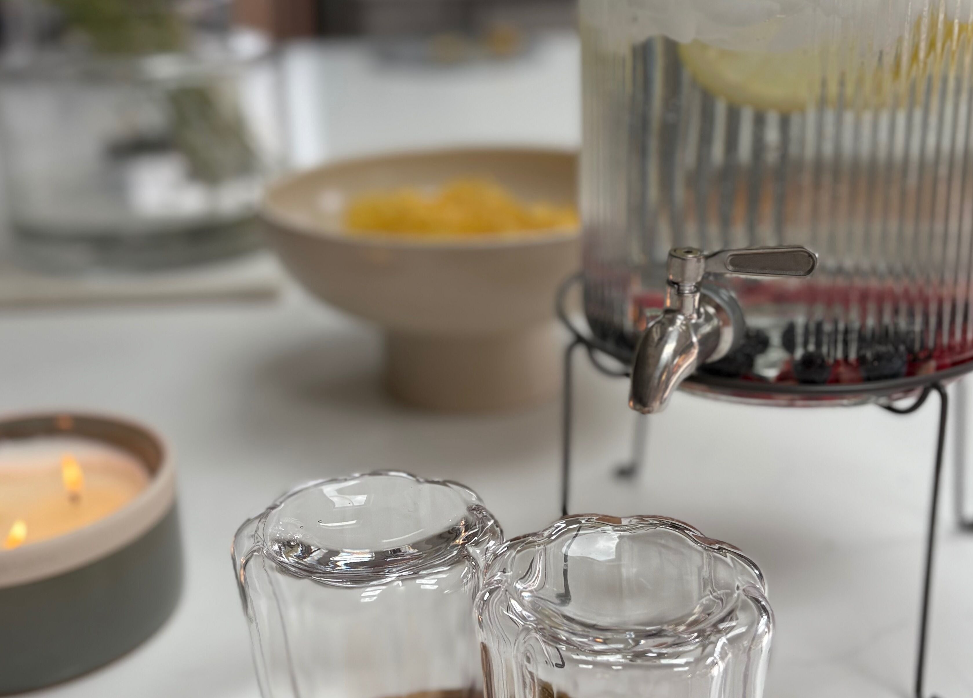 Refreshments with glasses and candle at Glow by Mykala, Carlton, England, GB.