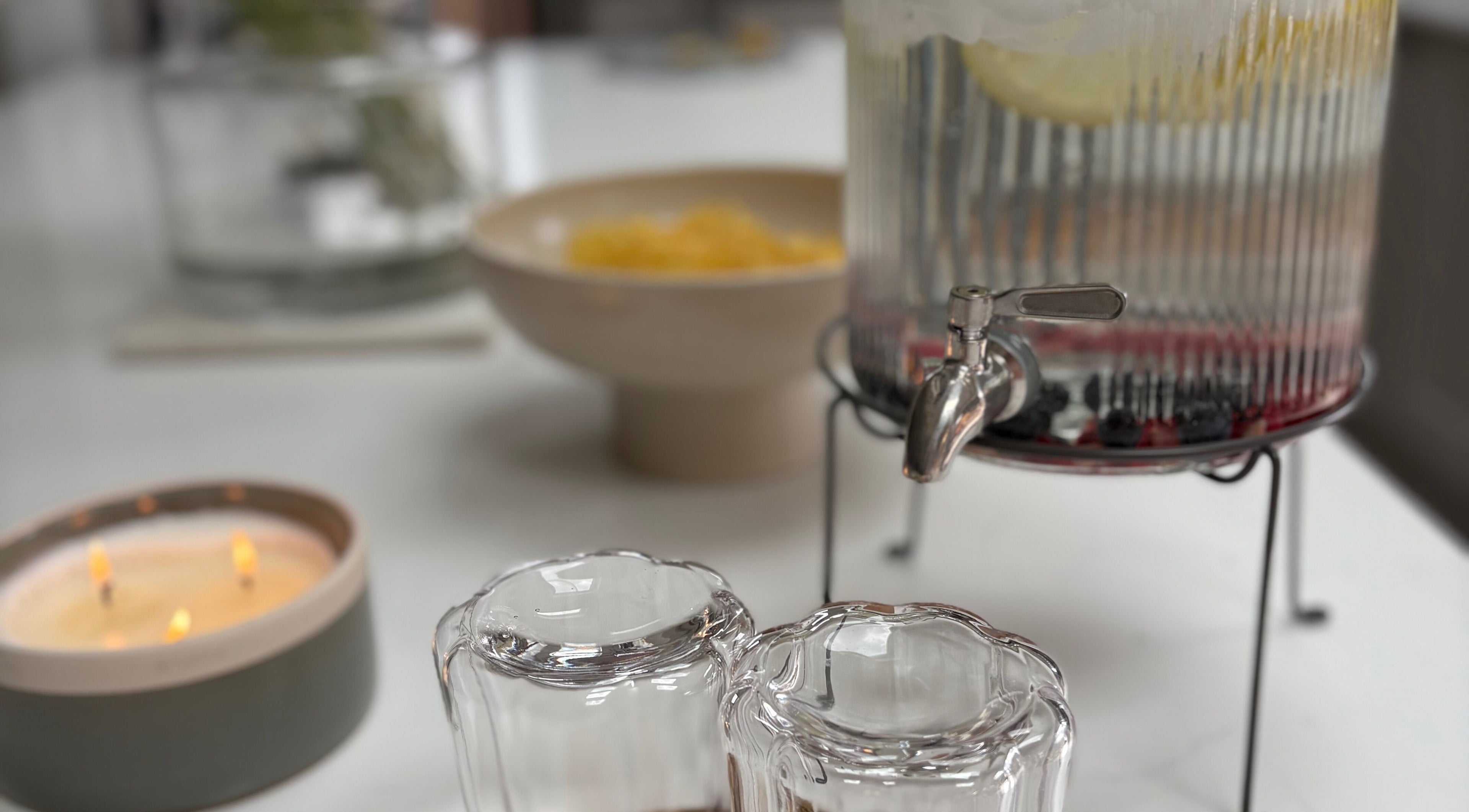 Refreshments with glasses and candle at Glow by Mykala, Carlton, England, GB.