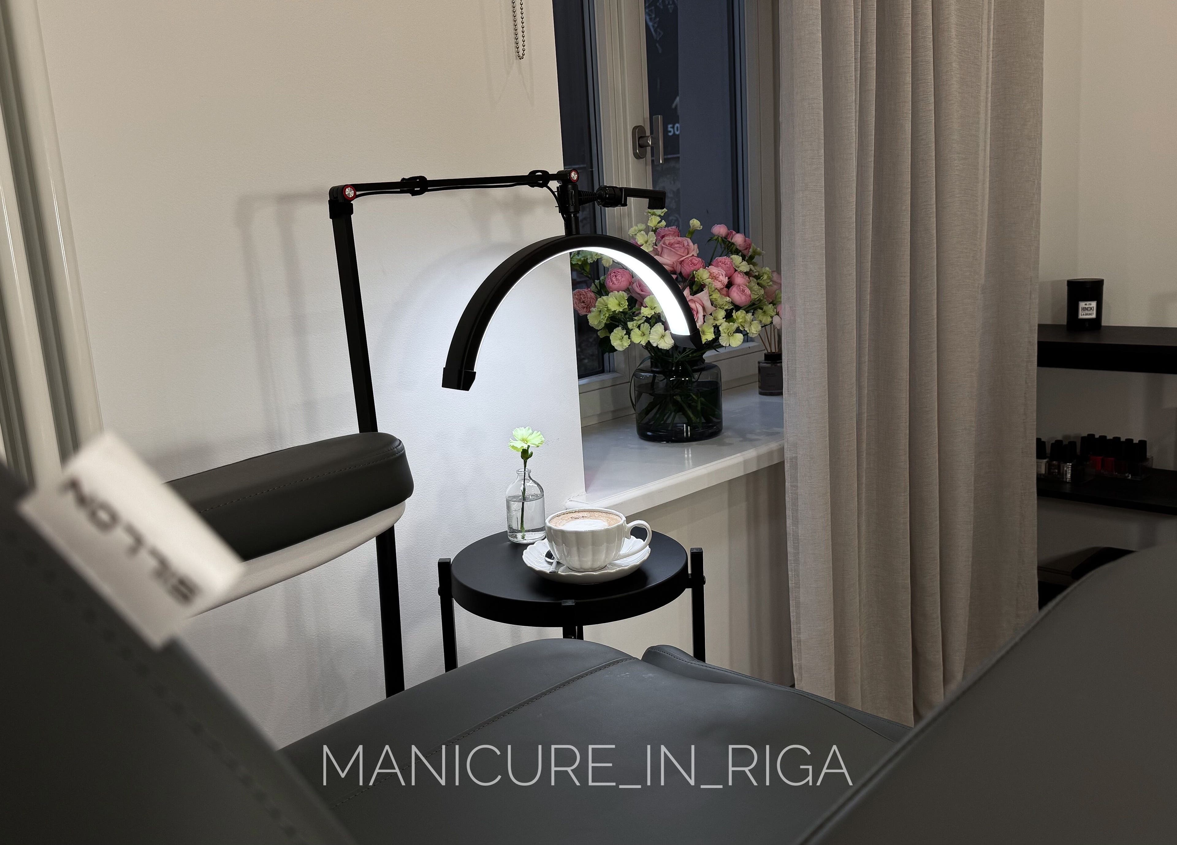 Cozy manicure setup at Manicure in Riga, Rīga, LV with flowers and coffee.