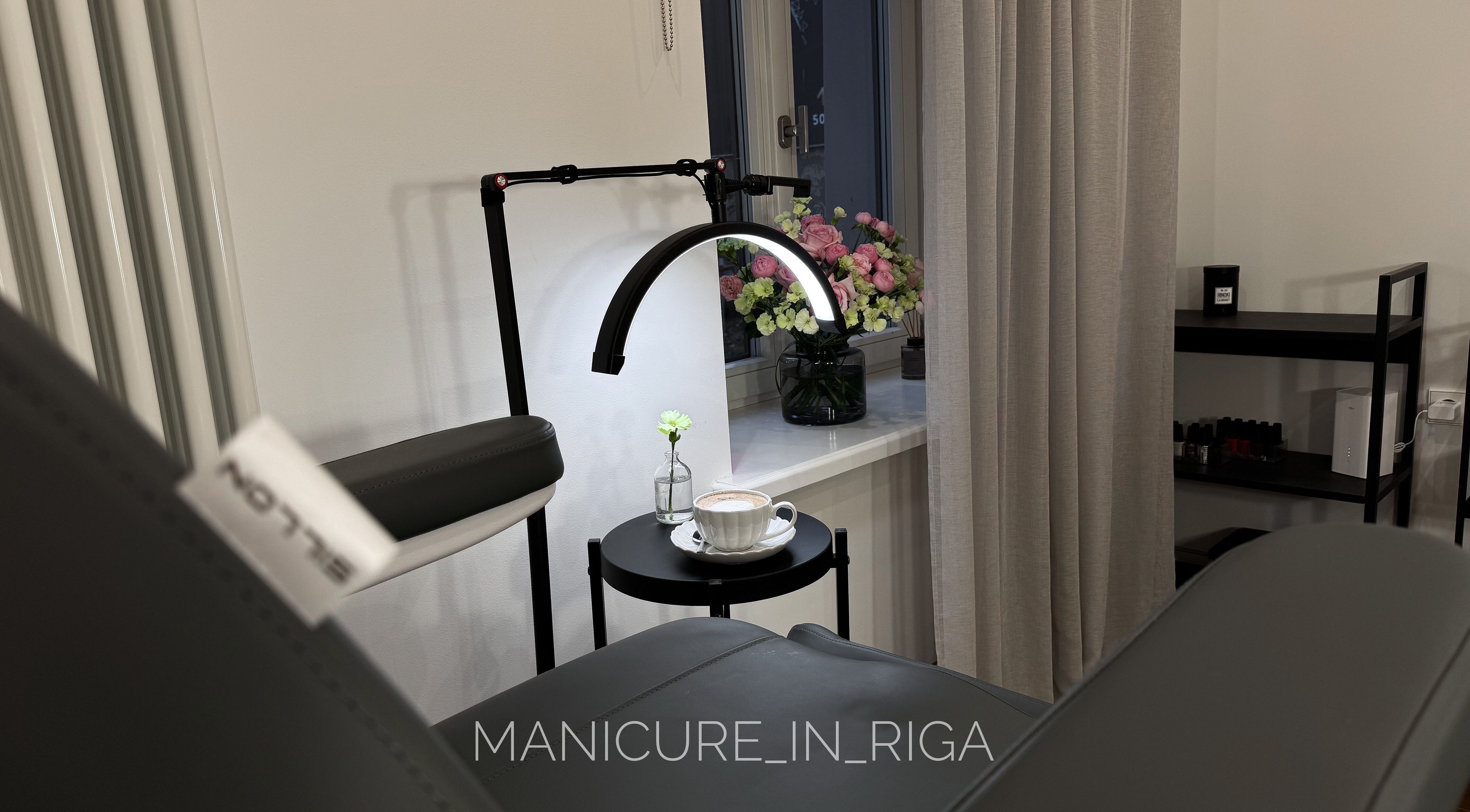 Cozy manicure setup at Manicure in Riga, Rīga, LV with flowers and coffee.