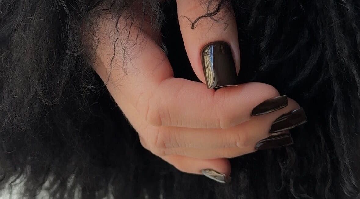 Elegant dark manicure in Riga with sleek black nails, located at Rīga, LV.