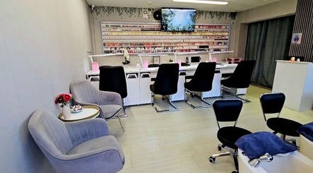 Spacious interior of Nail Bar Wicklow, Wicklow, County Wicklow, IE, featuring chic nail stations and plush seating.
