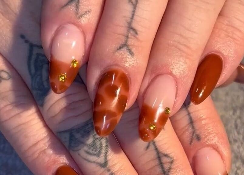 Stylish amber nail art at Niamh&Co, Stanford-le-hope, England, GB showcasing elegant designs.