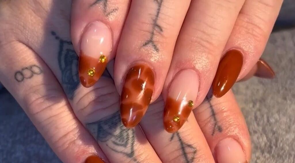 Stylish amber nail art at Niamh&Co, Stanford-le-hope, England, GB showcasing elegant designs.