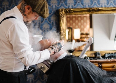 Vintage shaving service at Gents Barber Shop Queenstown, Queenstown, Otago Region, NZ with steaming technique.