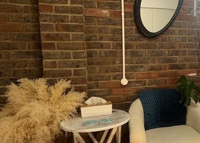 Cozy seating area at Gorgeous Gate Aesthetics in Burgess Hill, England, GB with stylish decor and brick wall.