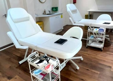 Modern treatment room at Hindle Luxx Aesthetics, Manchester, England, GB with sleek chairs and equipment.