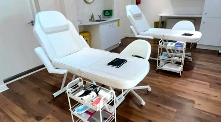 Modern treatment room at Hindle Luxx Aesthetics, Manchester, England, GB with sleek chairs and equipment.