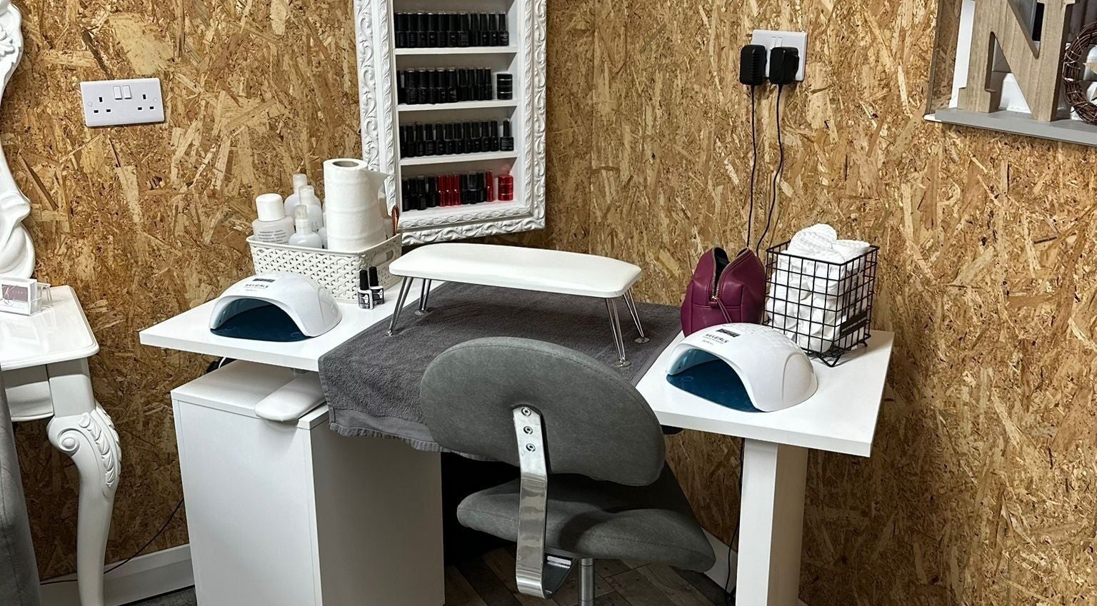 Manicure station at Kcee’s Hair And Beauty, Walsall, England, GB, featuring nail polish and tools.