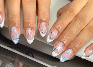 Elegant nail art with blue flowers at Lustrée Nails, Northampton, England, GB.