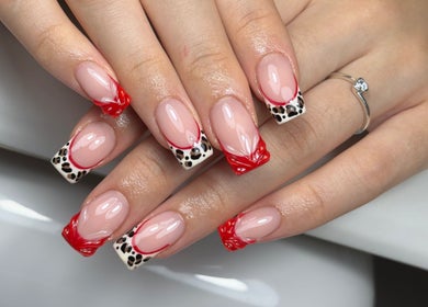 Stylish nail art with red and leopard design at Lustrée Nails, Northampton, England, GB.