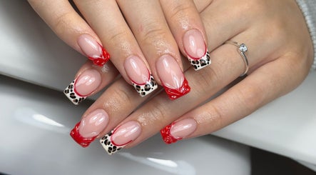 Stylish nail art with red and leopard design at Lustrée Nails, Northampton, England, GB.
