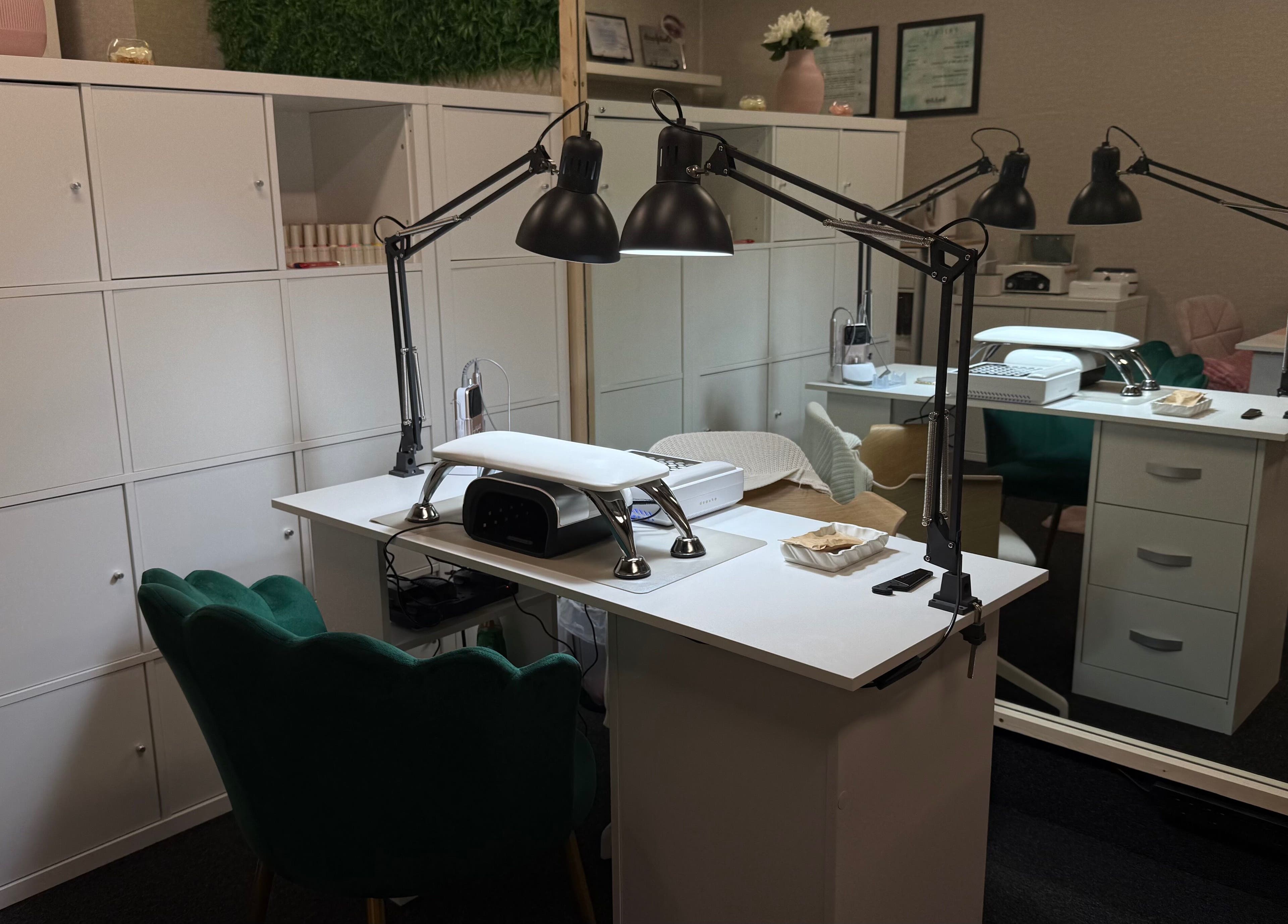 Chic nail station at Lustrée Nails in Northampton, England, GB, featuring modern lighting and elegant decor.