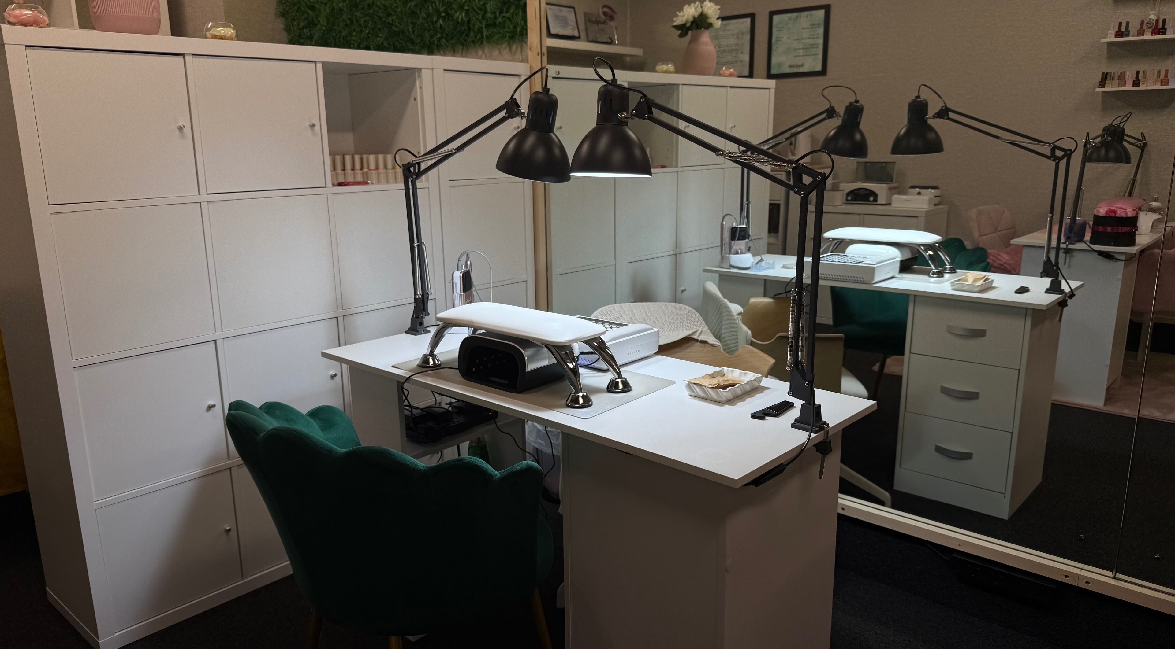 Chic nail station at Lustrée Nails in Northampton, England, GB, featuring modern lighting and elegant decor.