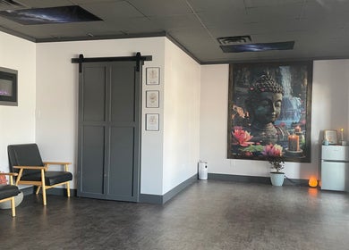 Relaxing reception area of Salt Spa II showcasing Buddha mural and seating in Newport, Tennessee, US.